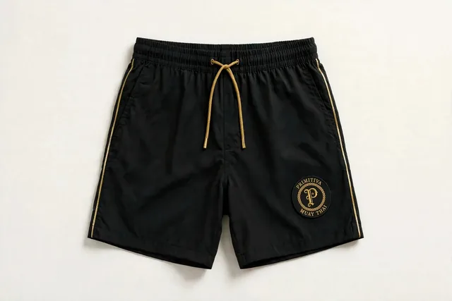 Primitiva short d’entraînement sportif en noir et doré avec l’emblème sur la jambe