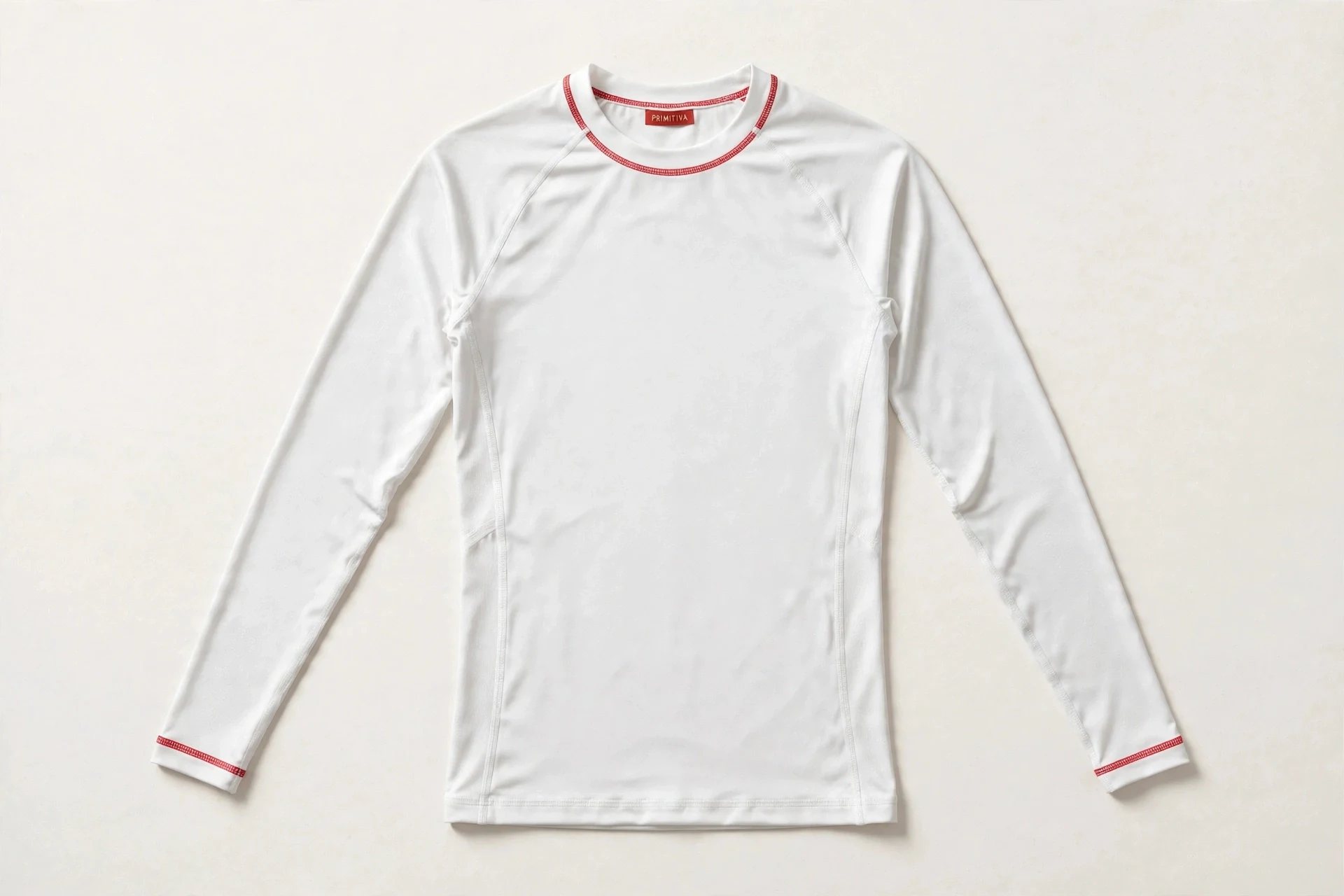 Primitiva long-sleeve compression shirt in white and red with the Primitiva neck tag