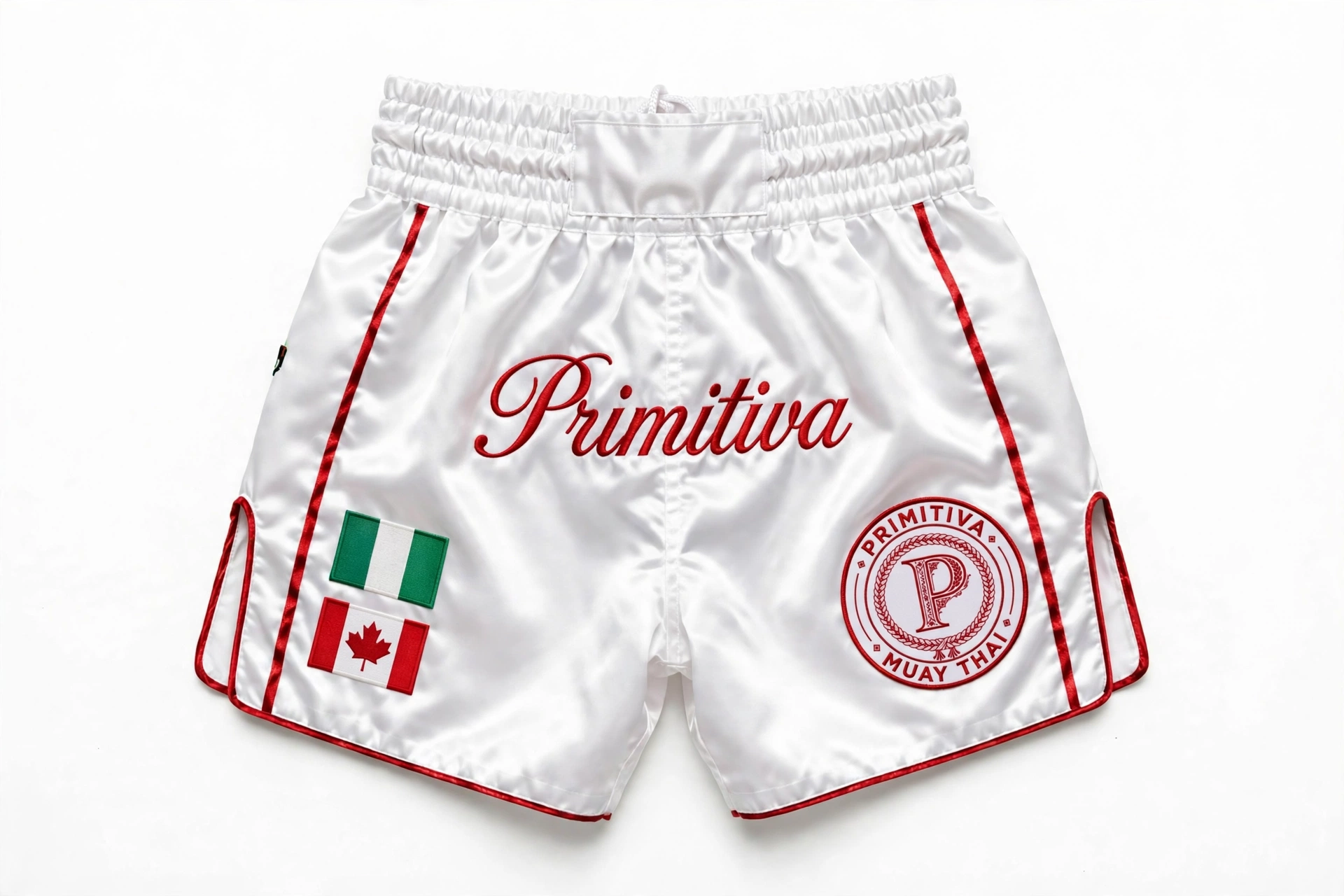 Primitiva fight shorts in white and red with Nigeria and Canada flags and waistband script