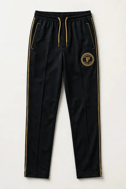 Primitiva pantalon de survêtement BG en noir et doré avec bande latérale et l’emblème sur la cuisse
