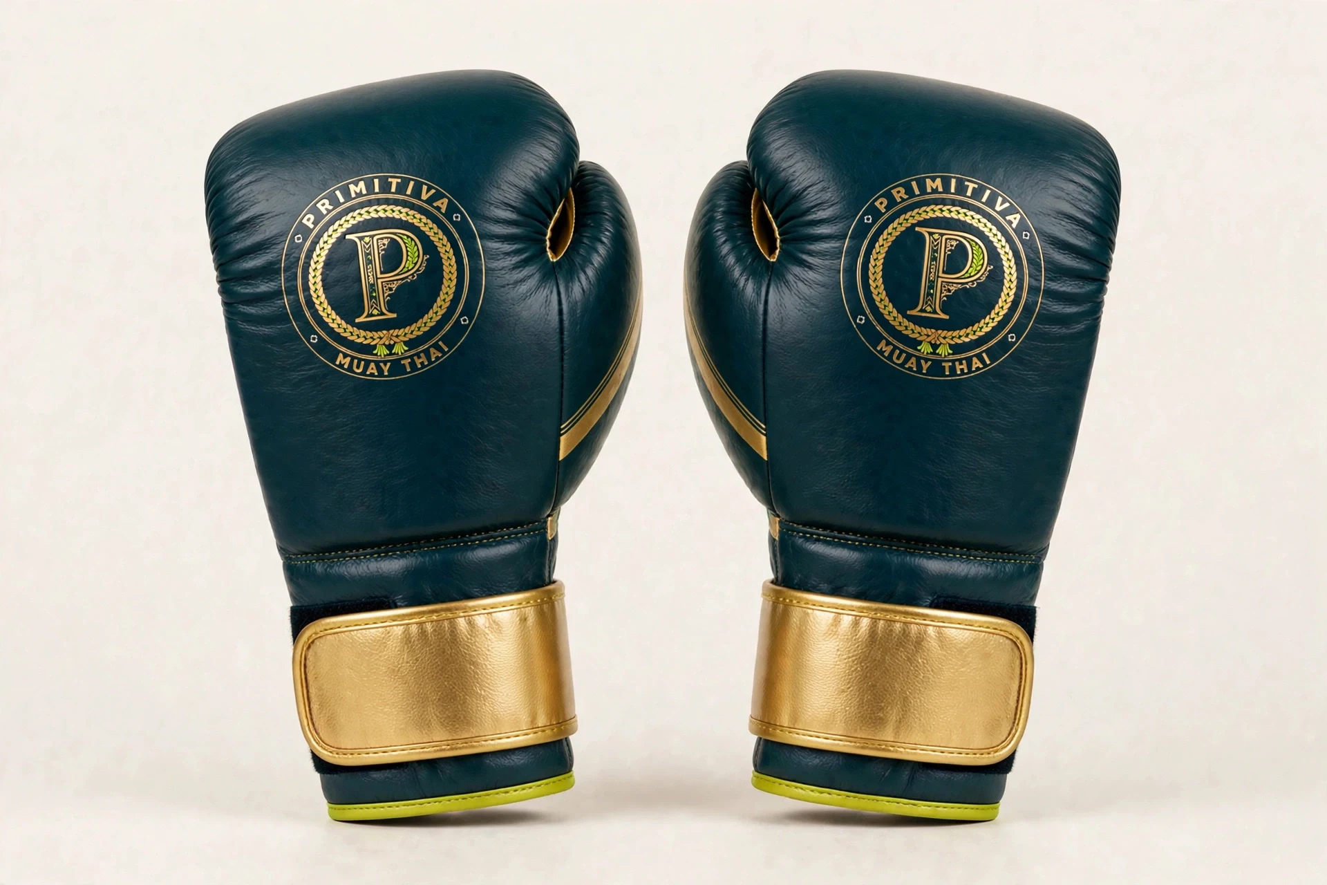 Primitiva training gloves in teal and gold — front view: the emblem on the fist, gold velcro strap